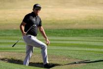 Phil Mickelson walks out from a bunker after hitting to the 17th green during the first round o ...