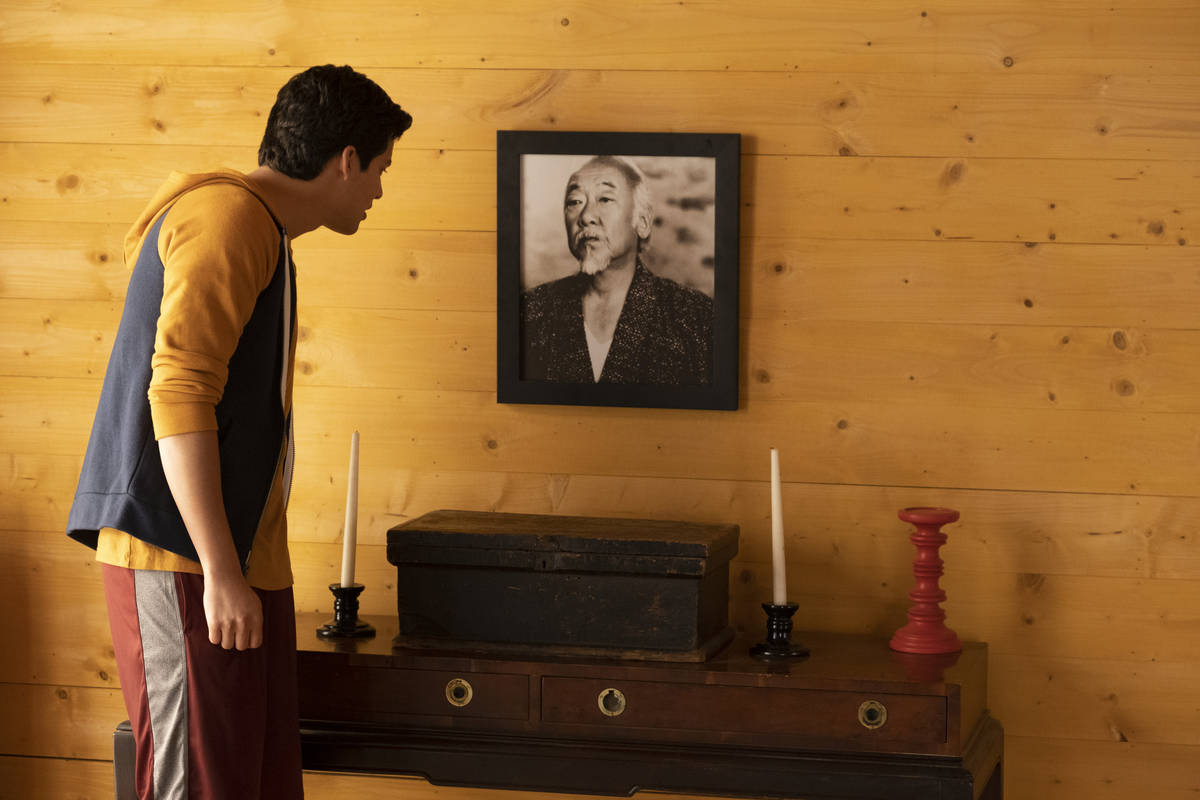 Xolo Mariduea as Miguel Diaz looks at a photo of Mr. Miyagi (Pat Morita) in episode 309 of "Cob ...