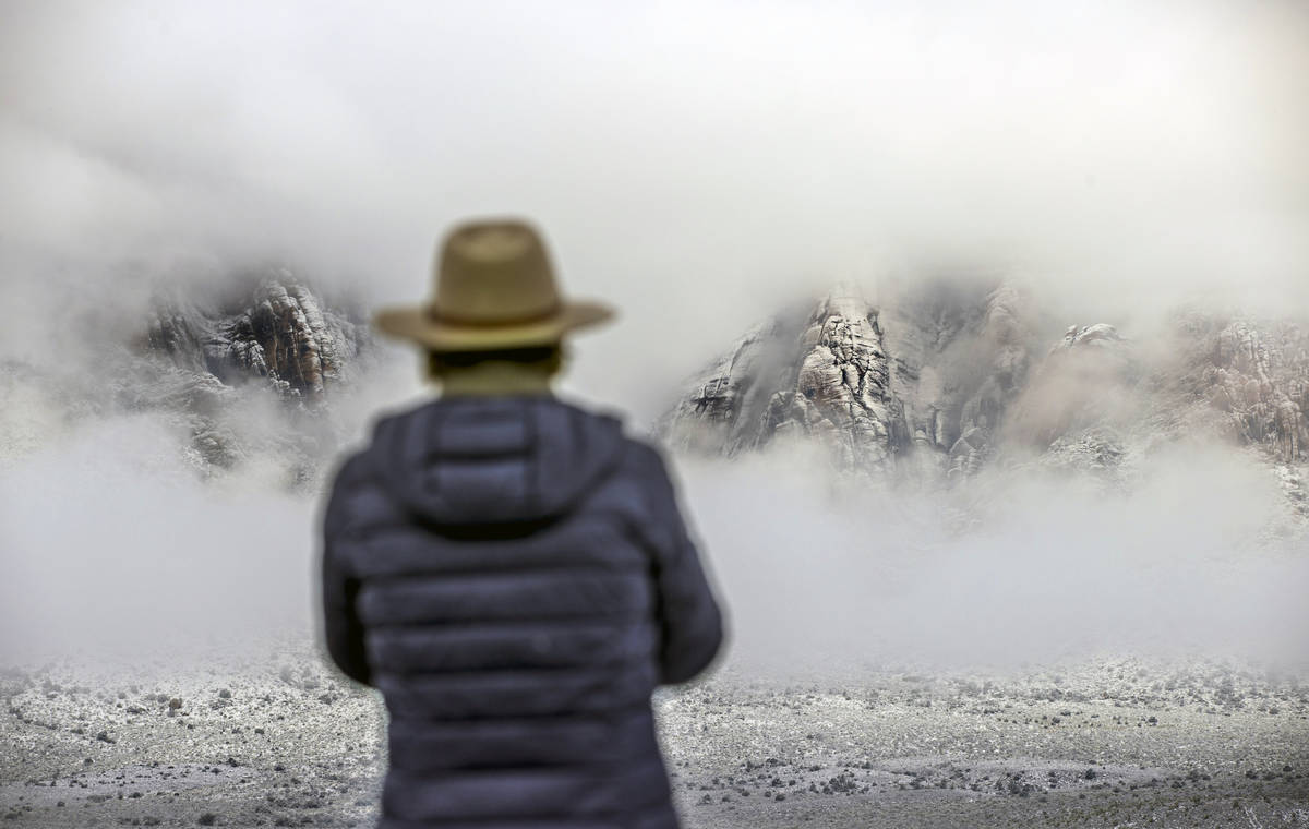 The clouds begin to break about the mountain range near the overlook in the Red Rock Conservati ...