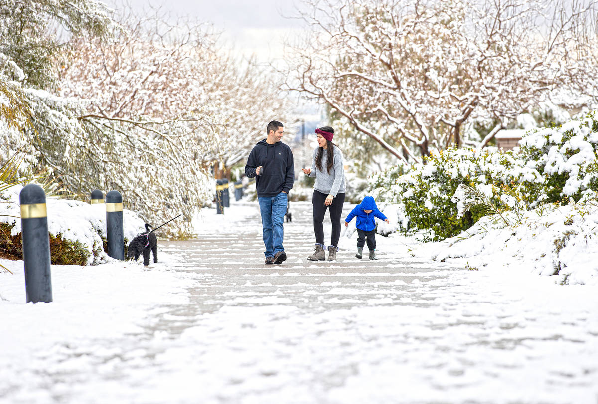 Grayson Mahar, 3, right, walks with his parents Ally and Sam along The Promenade in northwest L ...