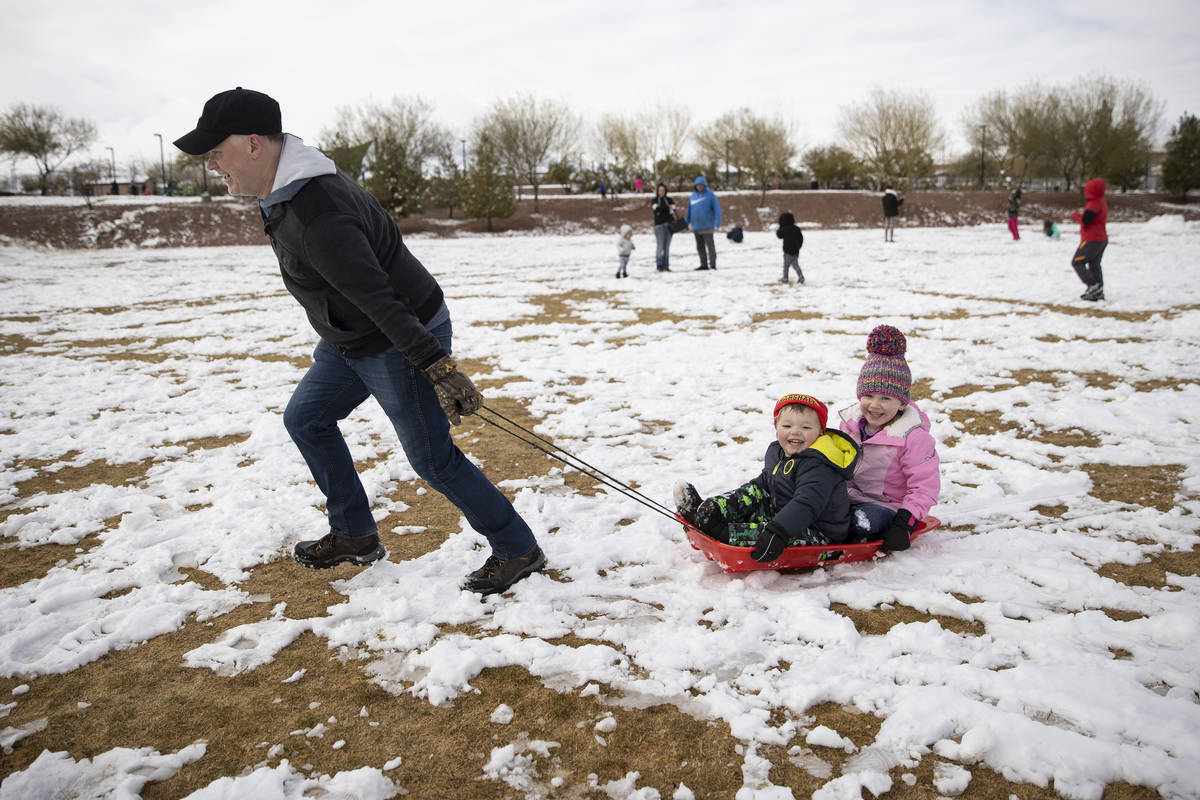 Darrin Goheen plays with his children Lucas, 3 and Riley, 5, at Huckleberry Park in Las Vegas, ...