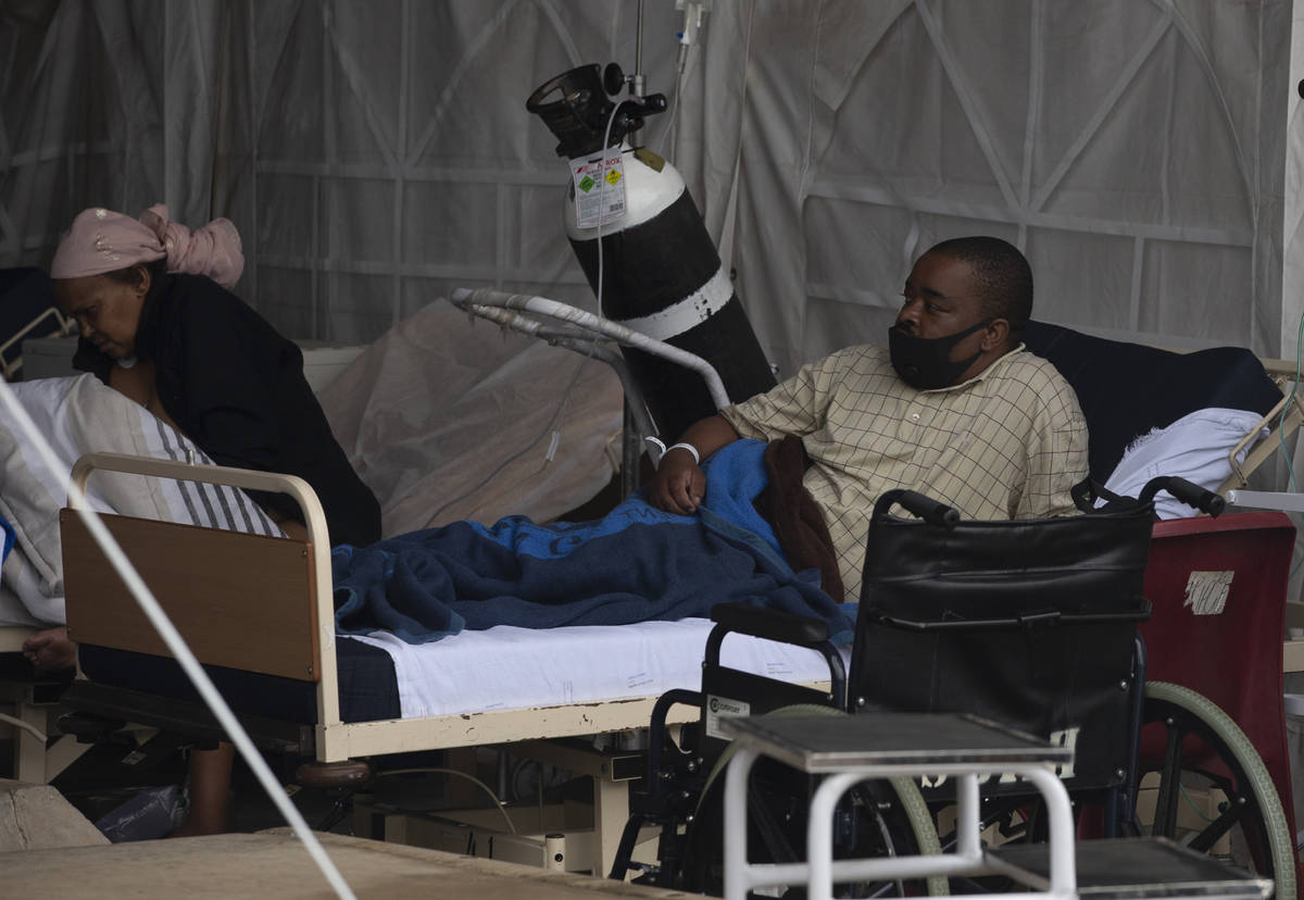 A patient lays in his bed at the Steve Biko Academic Hospital's outside parking area in Pretori ...