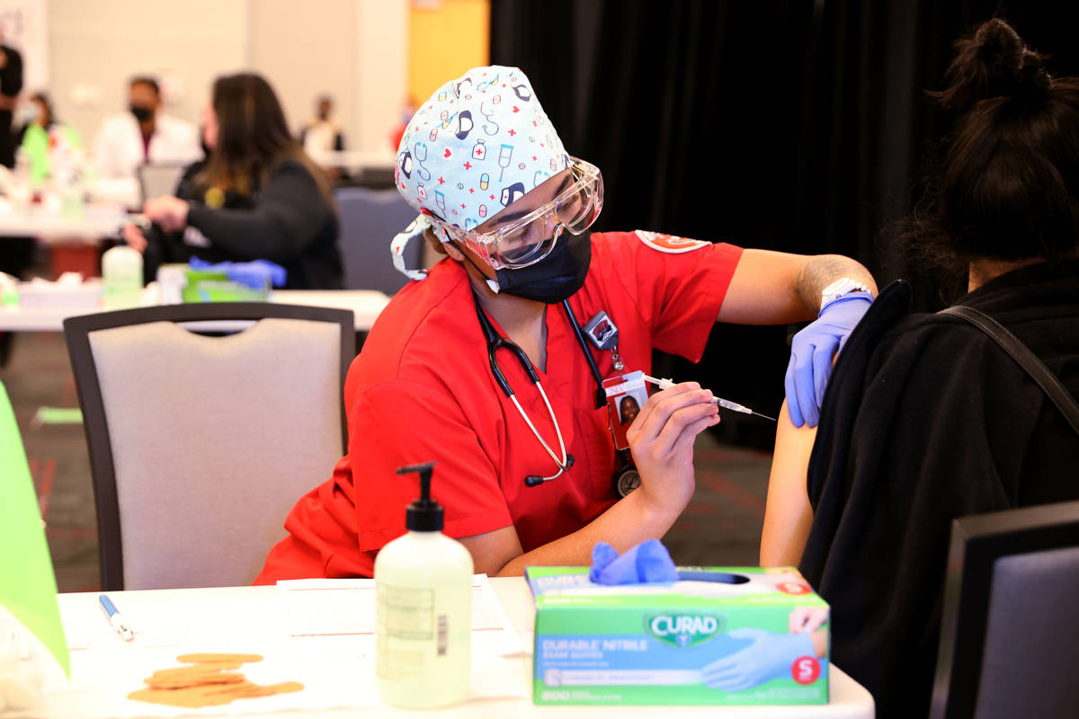 Nursing student Alaysia Robinson gives a COVID-19 vaccine during a UNLV Medicine clinic in the ...