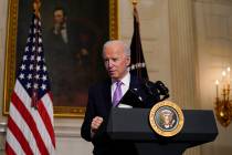 President Joe Biden leaves after delivering remarks on COVID-19, in the State Dining Room of th ...