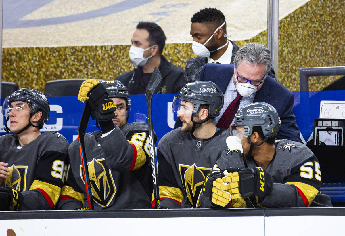 Golden Knights general manager Kelly McCrimmon, helping fill in on coaching duty, talks with pl ...