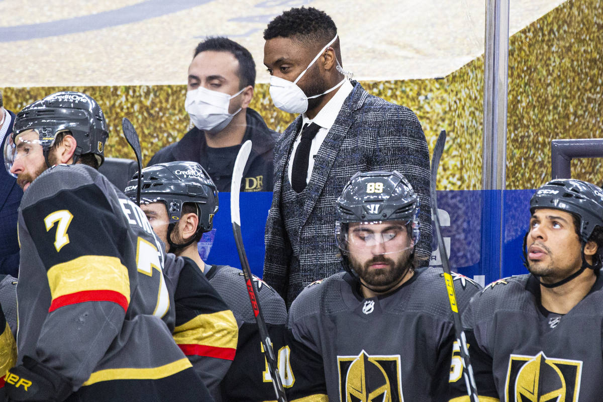 Silver Knights assistant coach Joel Ward, center, looks on from the Golden Knights bench during ...