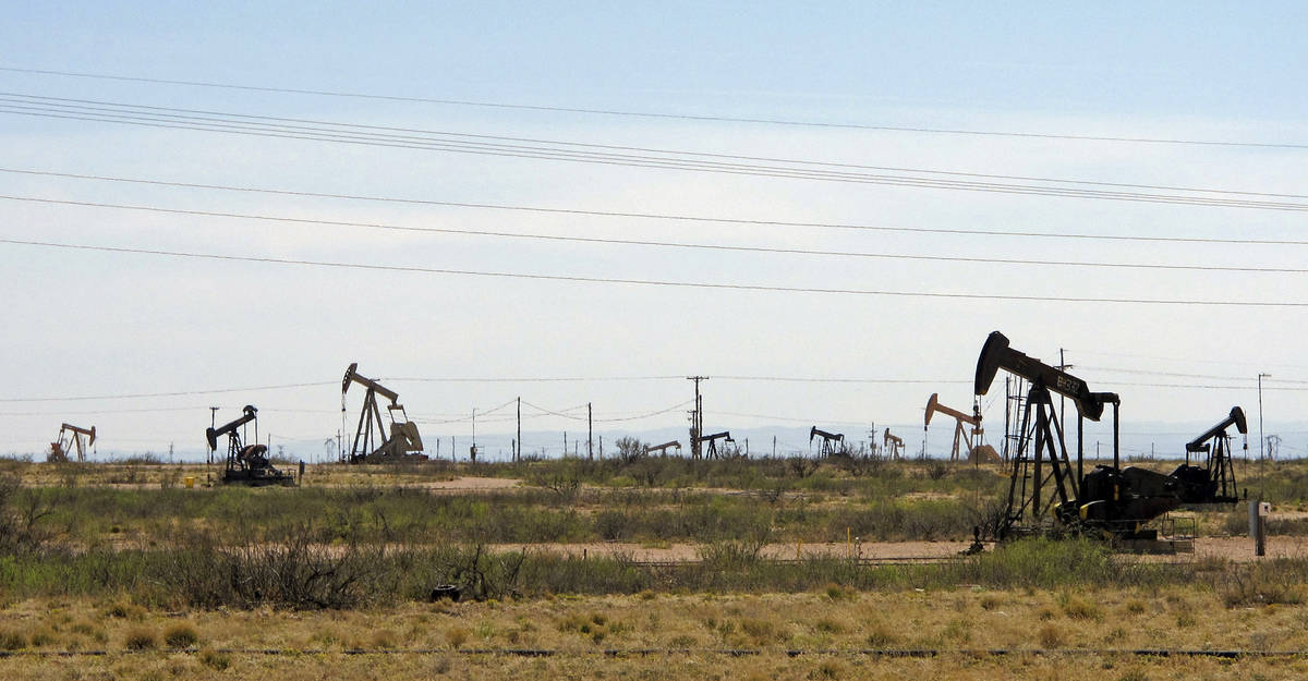 FILE - In this April 9, 2014, file photo, oil rigs stand in the Loco Hills field on U.S. Highwa ...
