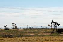 FILE - In this April 9, 2014, file photo, oil rigs stand in the Loco Hills field on U.S. Highwa ...