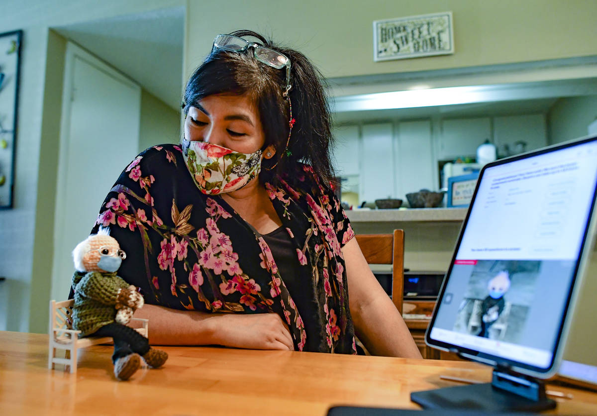Tobey King speaks to her crochet Bernie Sanders doll as the bidding continues on eBay on Tuesda ...