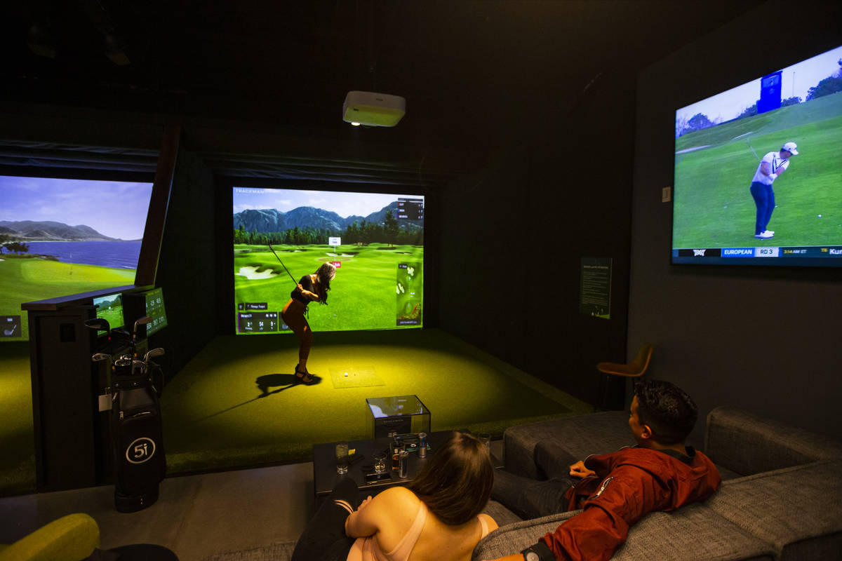 Brizha Castaneda, of Las Vegas, takes a swing during a friends and family event at Five Iron Go ...