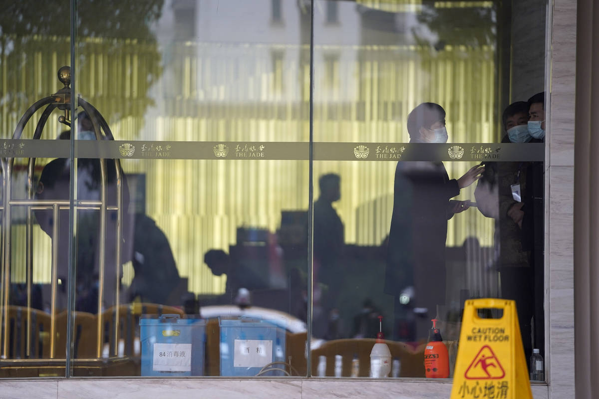 Workers are seen inside hotel where a team of experts from the World Health Organization are qu ...