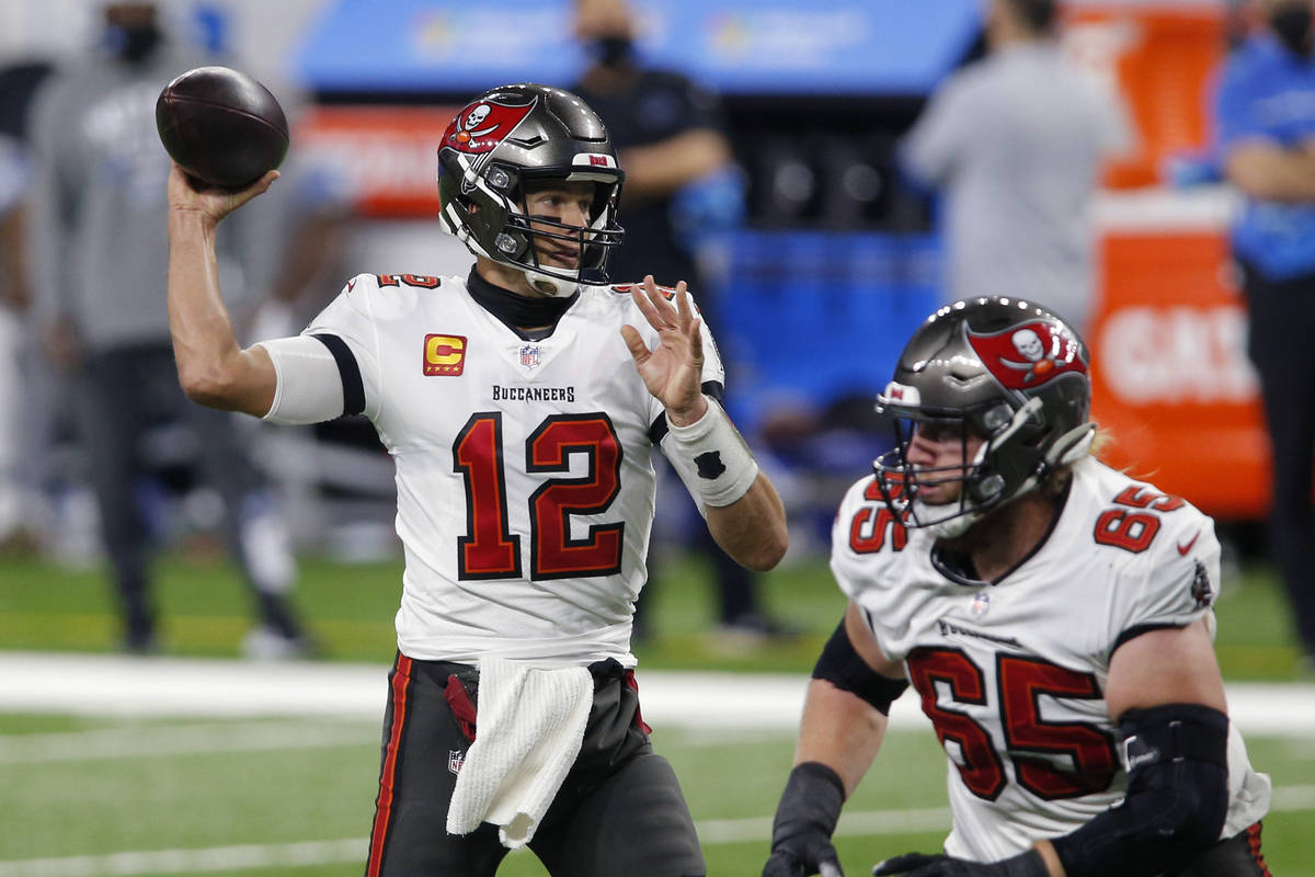 Tampa Bay Buccaneers quarterback Tom Brady (12) throws a pass as offensive guard Alex Cappa (65 ...