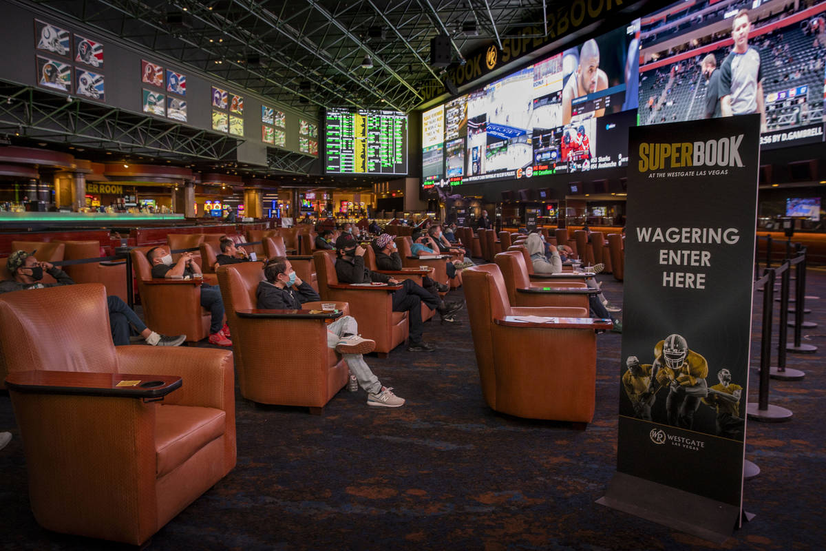 People sit and watch the events broadcasted as the Westgate sportsbook posts hundreds of Super ...