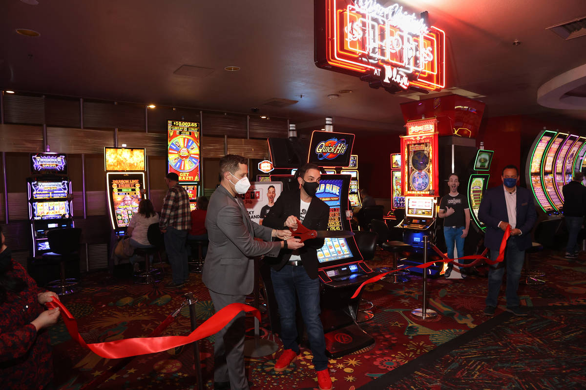 Slot machine YouTuber Brian Christopher, right and Plaza CEO Jonathan Jossel cut the ribbon on ...