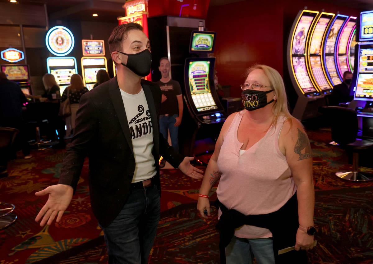Slot machine YouTuber Brian Christopher visits with Kelly DeGeorge, 55, during a ribbon-cutting ...
