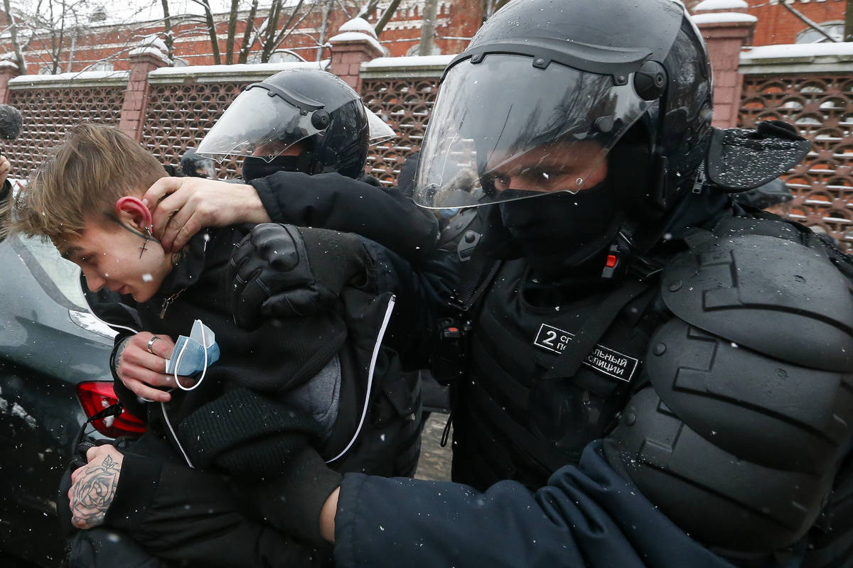 Police officers detain a young demonstrator during a protest near the Matrosskaya Tishina priso ...