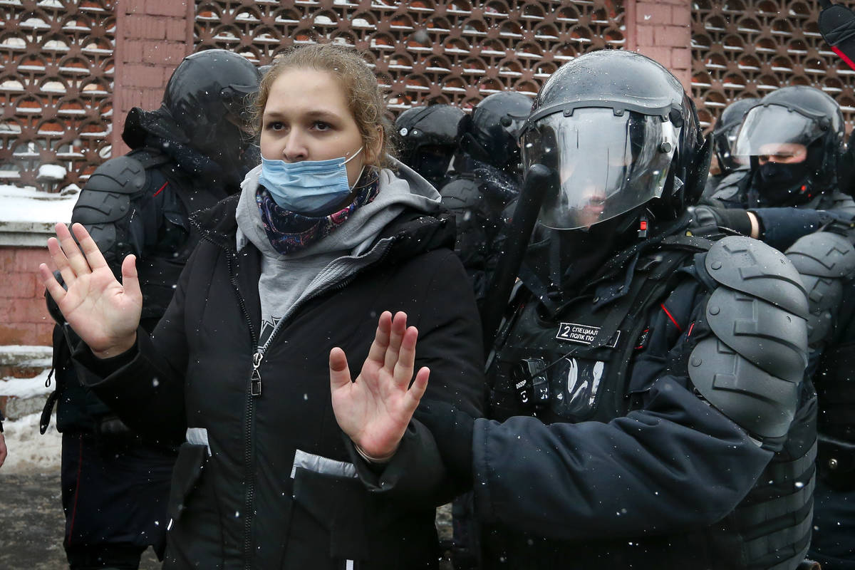 Police officers detain a young demonstrator during a protest near the Matrosskaya Tishina priso ...