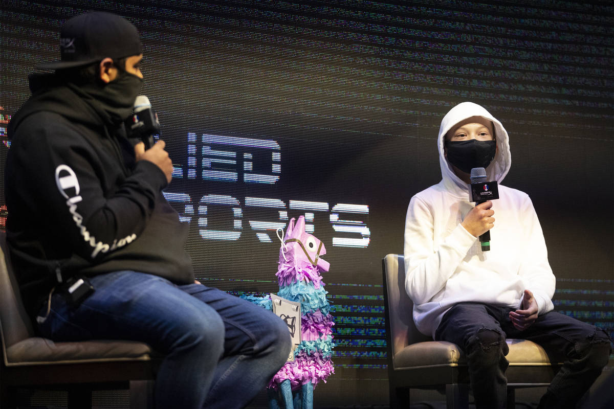 Enzo Durand, 13, right, is inteviewed by host Noor Jehangir, during the Fortnite tournament &qu ...