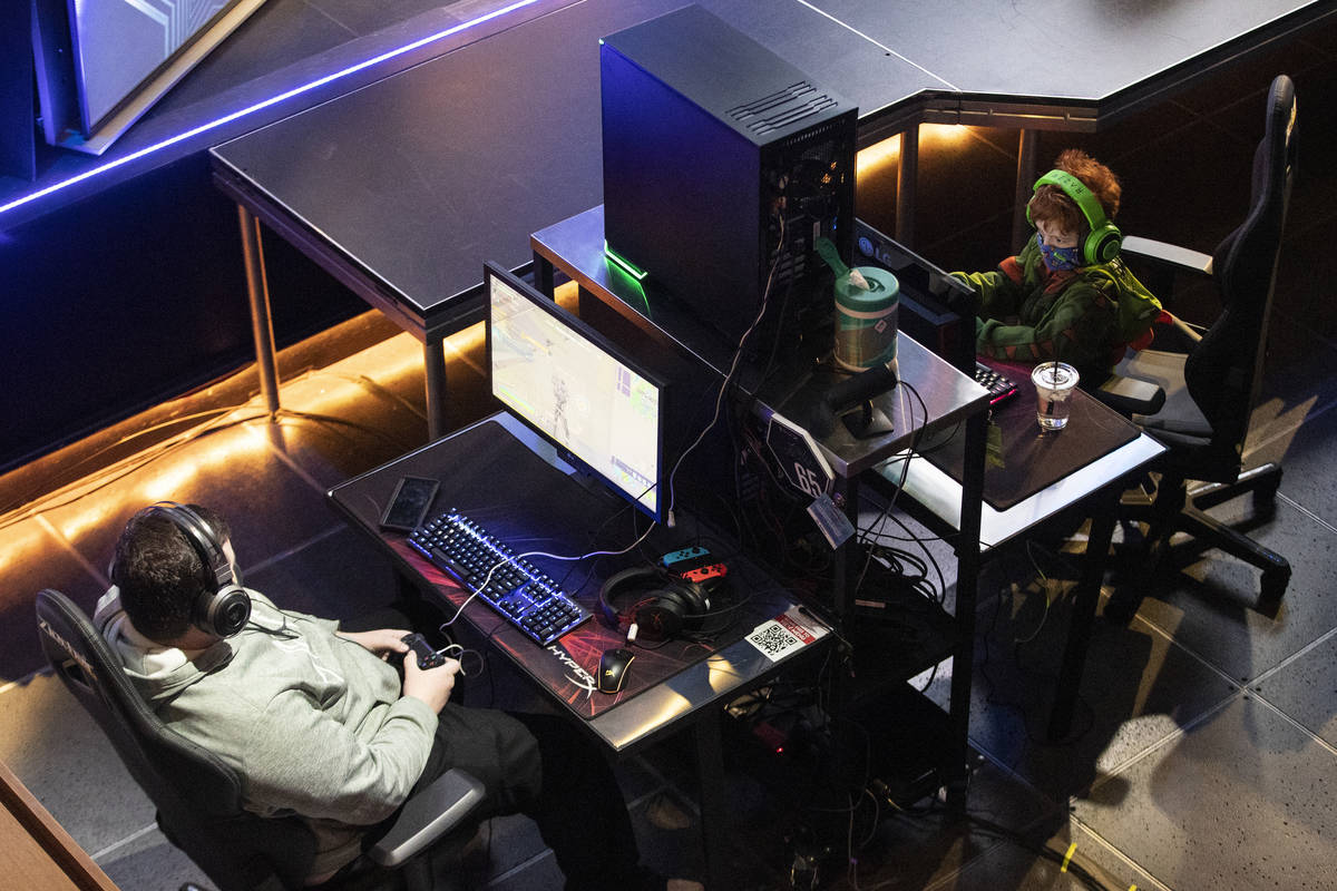 Players including Liam Lose, 7, of Las Vegas, right, get ready for the Fortnite tournament &quo ...