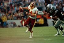Washington Redskins running back John Riggins is pursued by Los Angeles Raiders defenders inclu ...