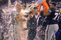 Oakland Raiders coach Bill Callahan gets doused with gatorade by Adam Treu, left, and Lincoln K ...