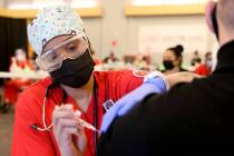Nursing student Alaysia Robinson gives a COVID-19 vaccine during a UNLV Medicine clinic in the ...