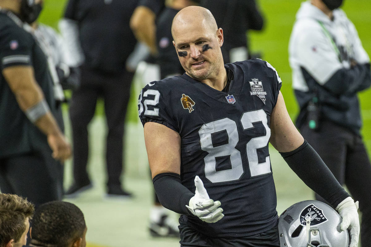 Raiders tight end Jason Witten (82) talks with teammates on the sidelines versus the Miami Dolp ...