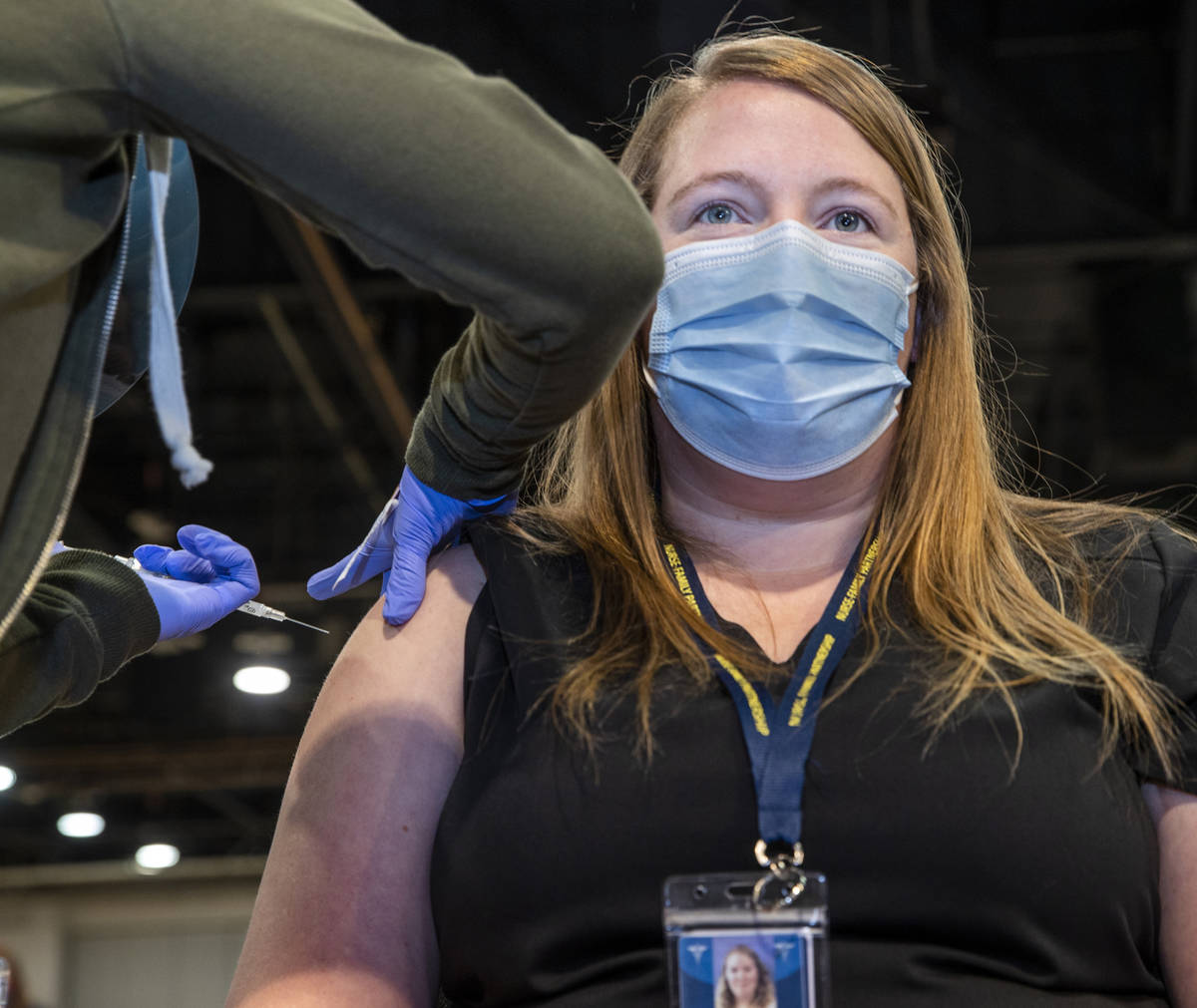 Jessica Johnson is injected with the Moderna vaccine at the Southern Nevada Health District's C ...