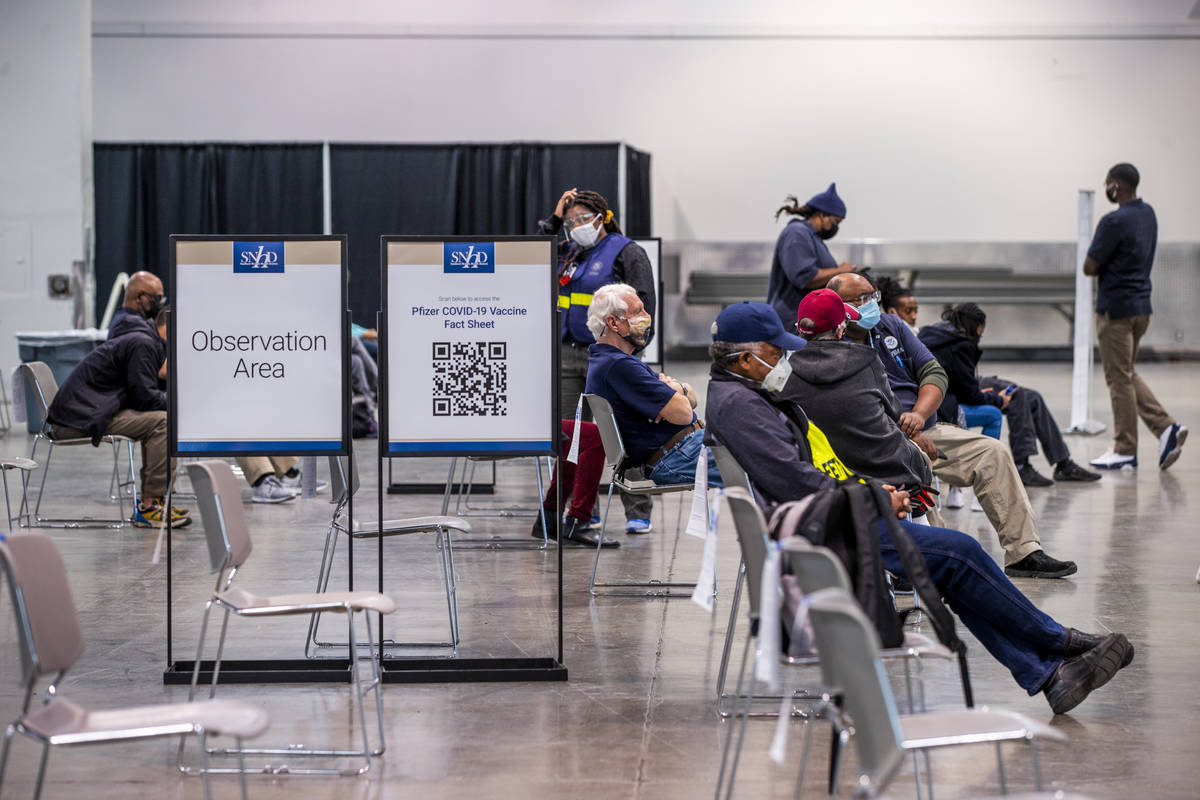 People sit in the observation area after receiving the Moderna vaccine at the Southern Nevada H ...