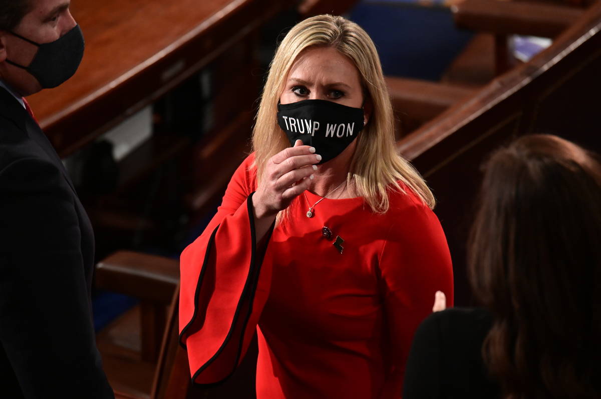 Rep. Marjorie Taylor Greene, R-Ga., wears a "Trump Won" face mask as she arrives on t ...