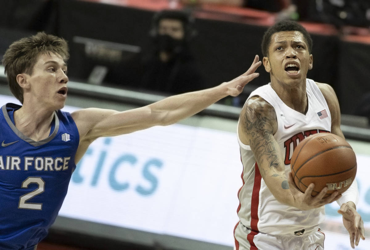 UNLV Rebels guard Nicquel Blake (22) drives past Air Force Falcons guard Glen McClintock (2) in ...