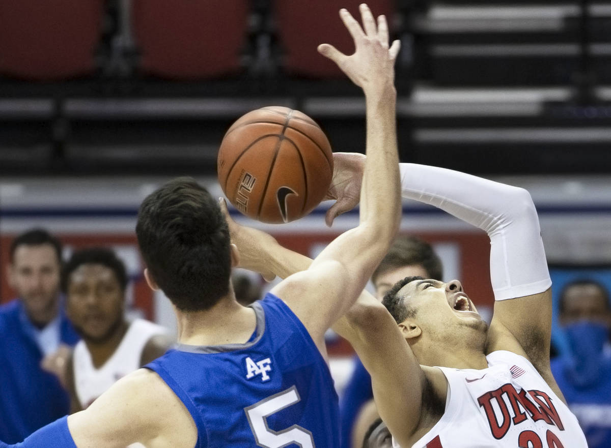UNLV Rebels forward Devin Tillis (30) slices to the rim past Air Force Falcons guard Chris Joyc ...
