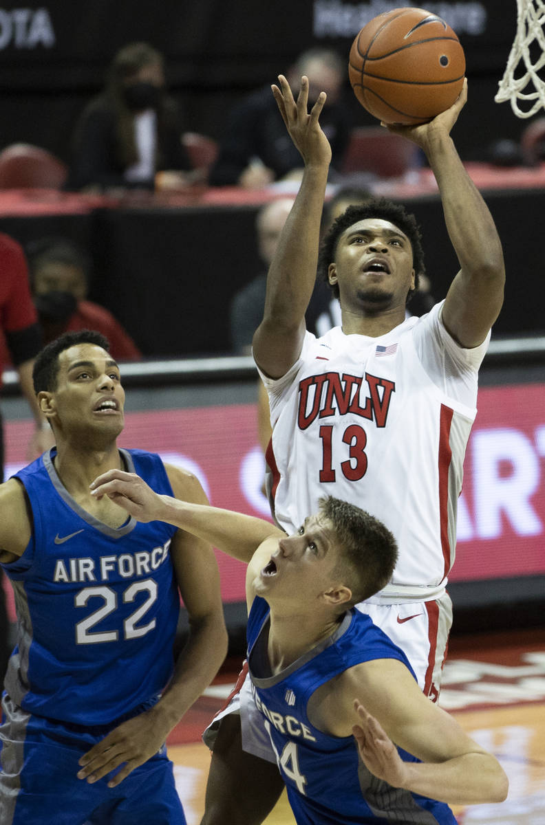 UNLV Rebels guard Bryce Hamilton (13) shoots over Air Force Falcons forward Nikc Jackson (22) a ...