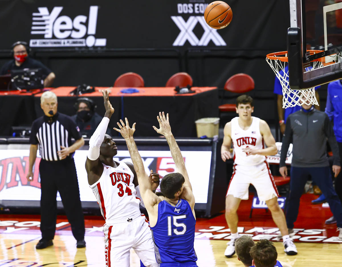 UNLV Rebels forward Cheikh Mbacke Diong (34) shoots over Air Force Falcons forward Abe Kinrade ...