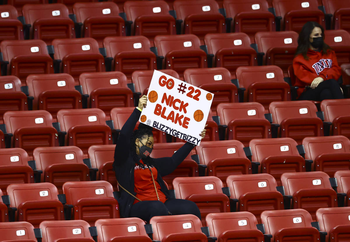 A UNLV fan cheers and holds up a sign for Rebels guard Nick Blake (22) during the second half o ...