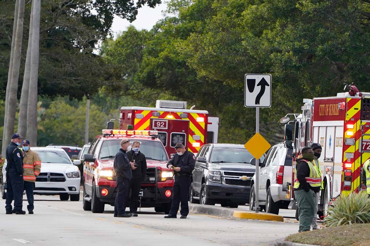 Law enforcement officers block an area where a shooting wounded several FBI while serving an ar ...