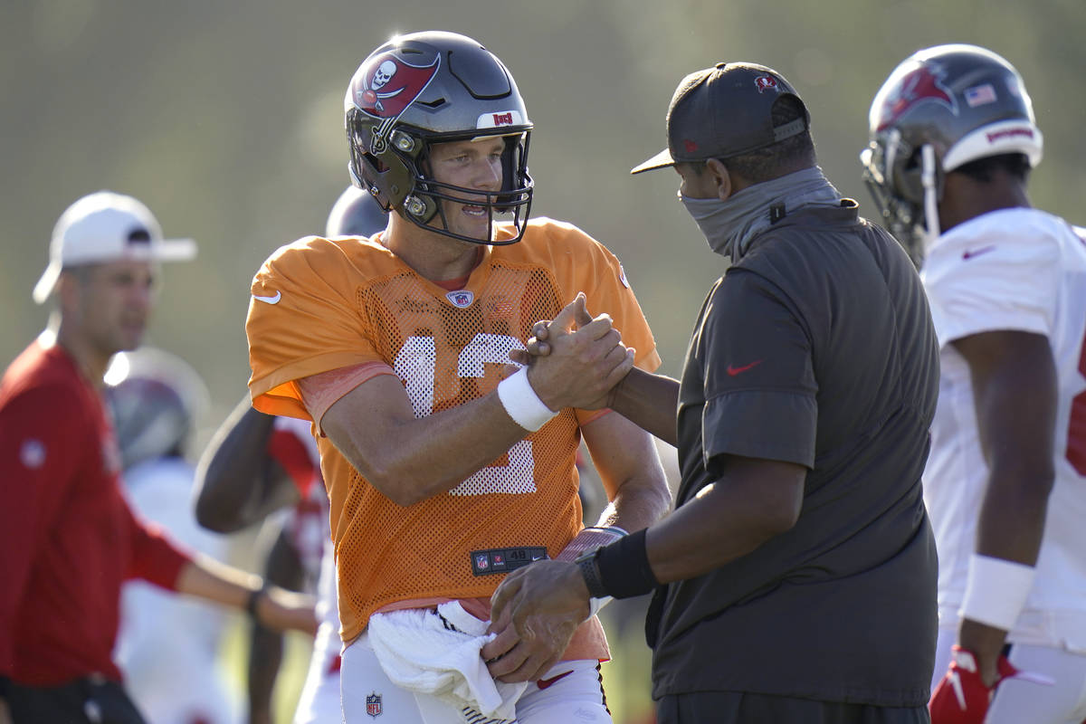 Tampa Bay Buccaneers quarterback Tom Brady (12) shakes hands with offensive coordinator Byron L ...