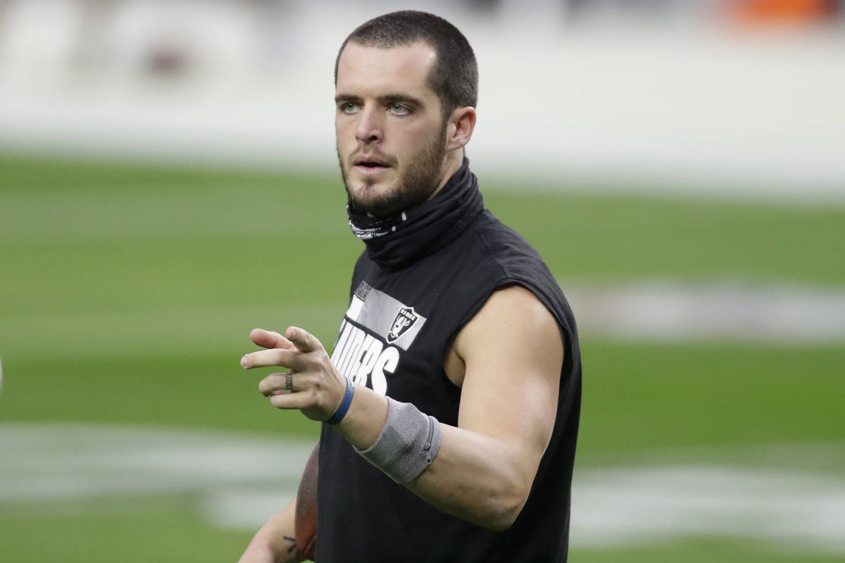 Las Vegas Raiders quarterback Derek Carr (4) warms up before an NFL football game against the I ...