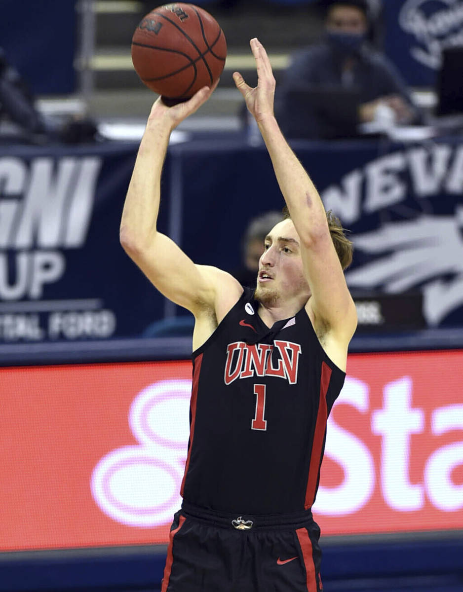 UNLV 's Moses Wood shoots for three against Nevada during the first half of an NCAA college bas ...