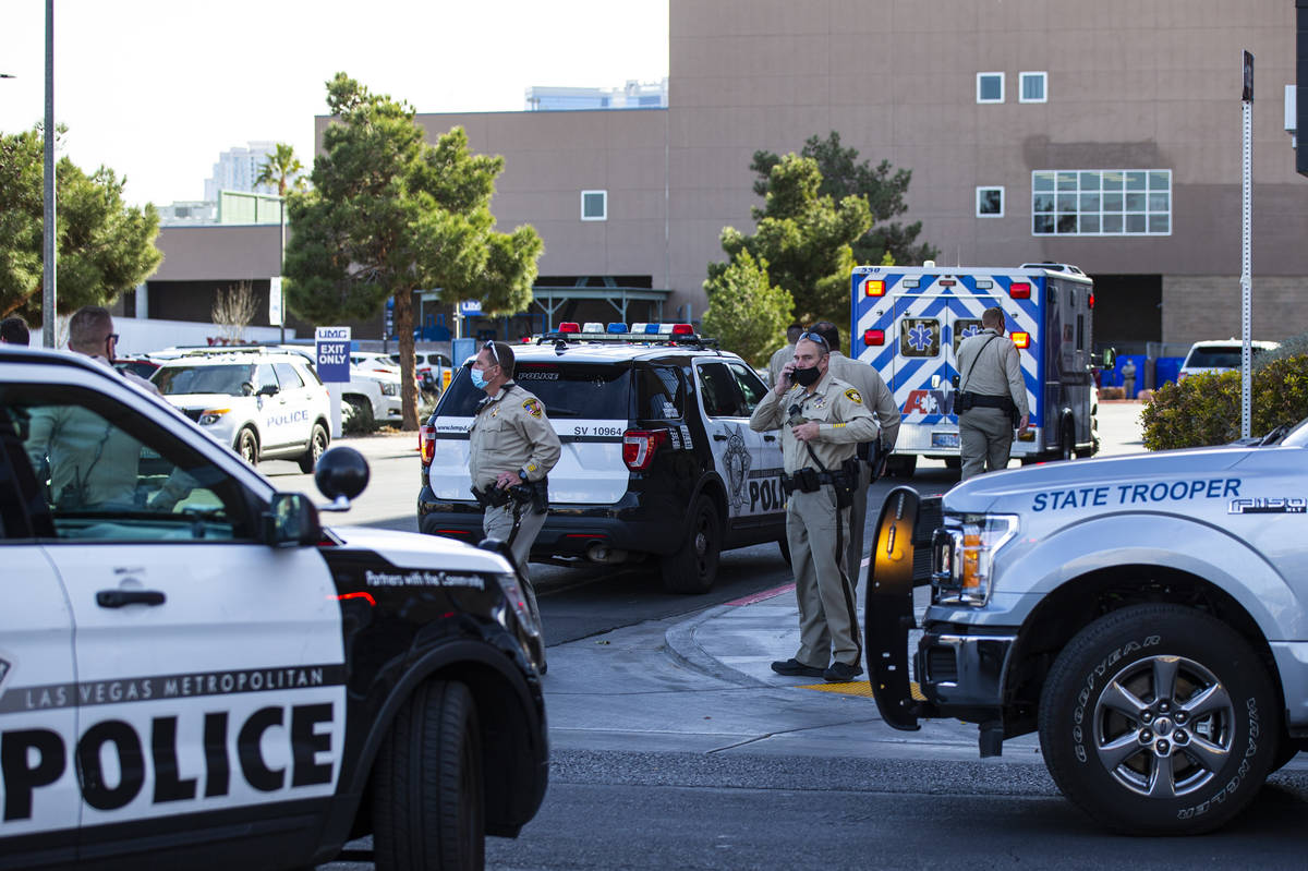 Las Vegas police and Nevada Highway Patrol troopers gather outside of University Medical Center ...