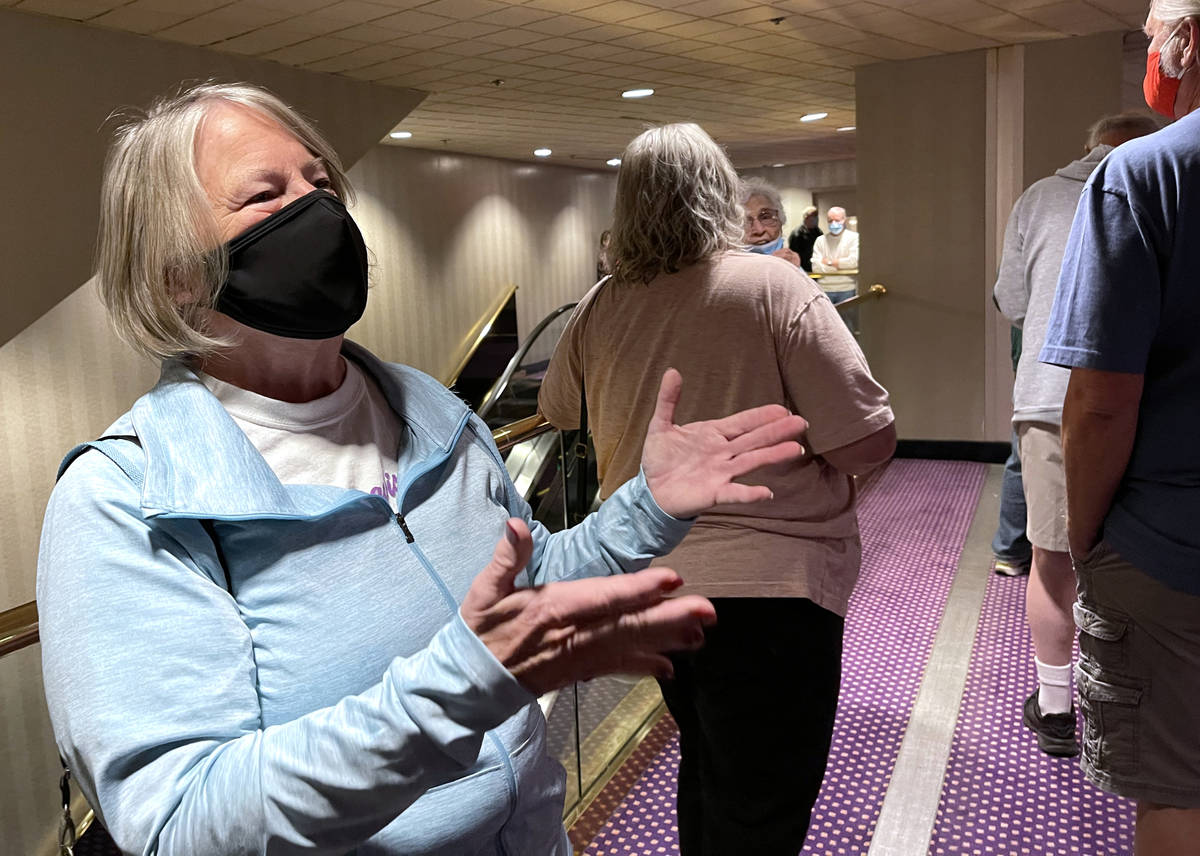 Jo-Ann Martin, 71, of Laughlin, talks to a reporter while waiting in line for a COVID-19 vaccin ...