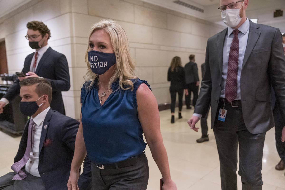 Rep. Marjorie Taylor Greene, R-Ga., walks with fellow House Republicans on Capitol Hill in Wash ...