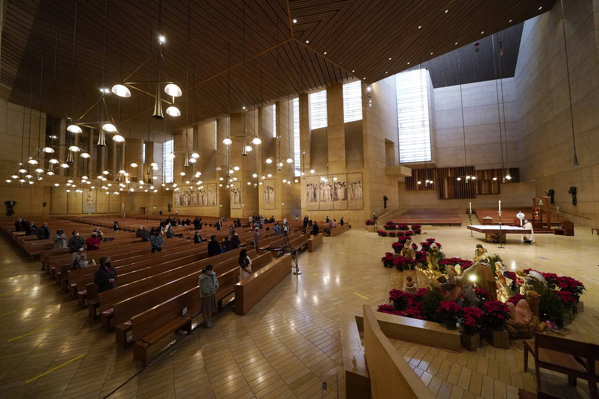FILE - In this Thursday, Dec 24, 2020, file photo, worshippers gather for Christmas Eve Mass at ...