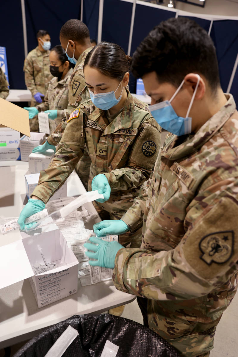Nevada National Guard members, Spc. Robert Hurtado, right, and Pfc. Julia Gobel, unload and pre ...