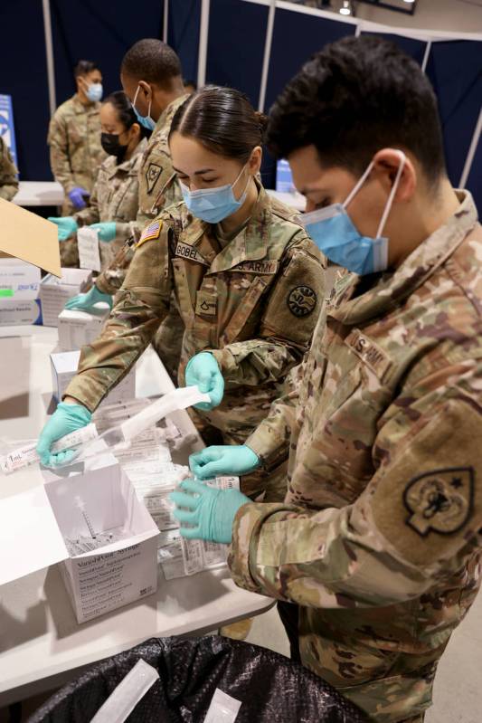 Nevada National Guard members, Spc. Robert Hurtado, right, and Pfc. Julia Gobel, unload and pre ...