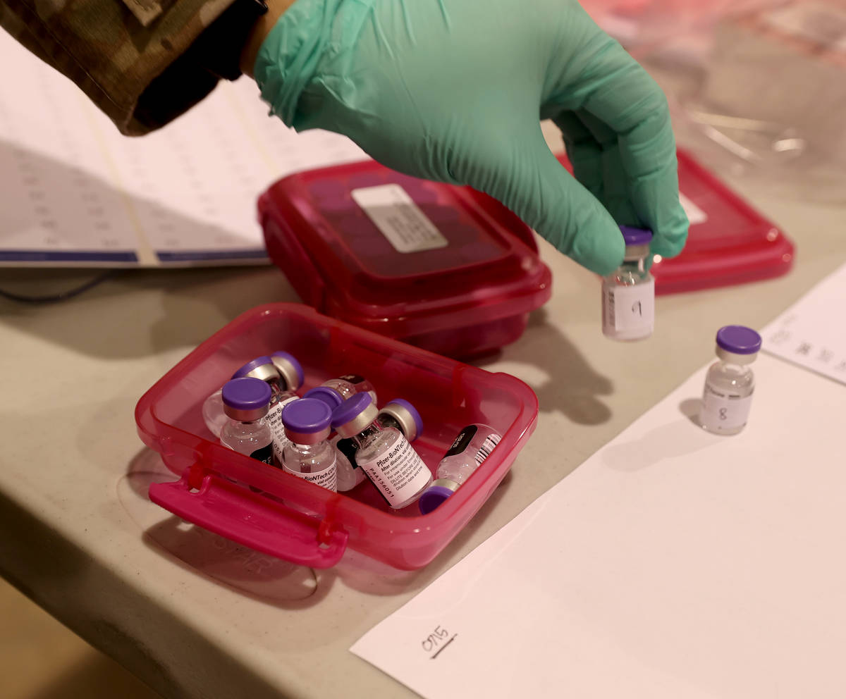 Nevada National Guard Sgt. Candy "D.T." Delatorre prepares Pfizer vaccine at the Cashman Center ...