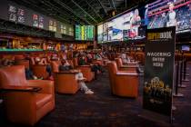 People sit and watch the events broadcasted as the Westgate sportsbook posts hundreds of Super ...