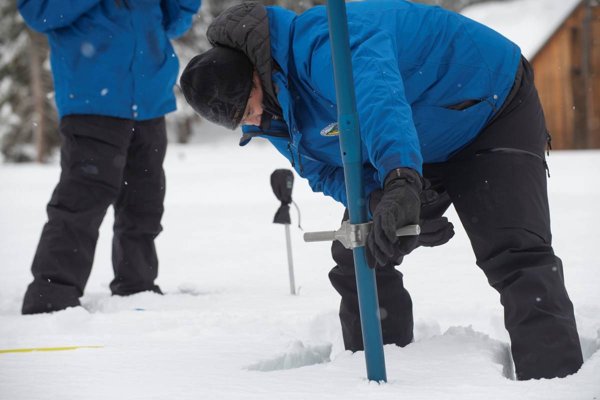 Sean de Guzman, chief of snow surveys for the California Department of Water Resources, measure ...