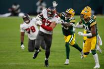 Green Bay Packers' Ka'dar Hollman (29) and Adrian Amos try to stop Tampa Bay Buccaneers' Rob Gr ...