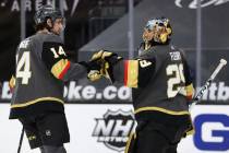 Vegas Golden Knights defenseman Nicolas Hague (14) and goaltender Marc-Andre Fleury (29) bump g ...